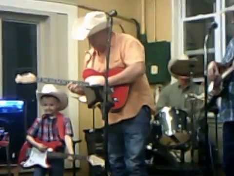 Levi Stephens playing his red guitar his daddy aka Bubba Stephens