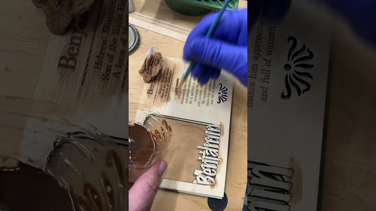 Finishing touches with stain on laser engraved sign