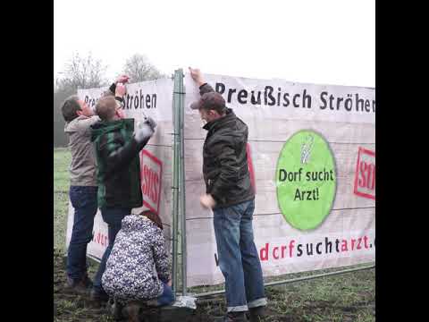 Dorf sucht Arzt - Preußisch Ströhen - Die ersten Banner werden aufgestellt.