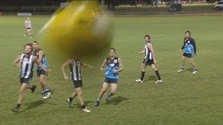 AFL Football - Cameraman hit with the ball