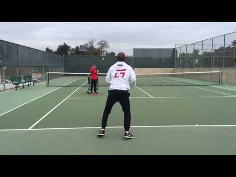 TeamG's Coach G demonstrating getting  under the ball and bending it into the court.