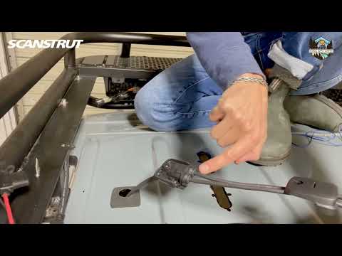 Routing solar panel cables through the roof of a van.