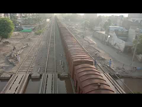 pakistan railways:longest freight train crossing rahim yar khan railway station in shining morning