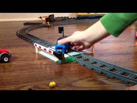 Lots of lego cars get crashed by lego train.
