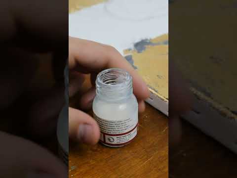 Applying gold leaf on canvas