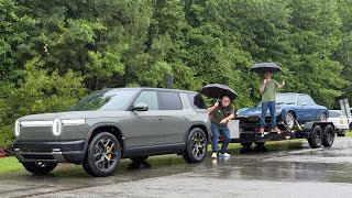 Rivian R2 towing a car hauler trailer