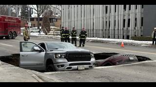BREAKING!! Sinkhole swallows two vehicles in Omaha’s Aksarben area.