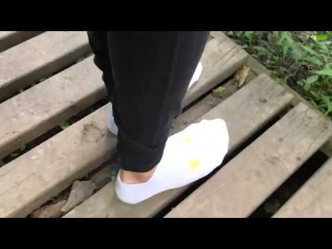 Getting new Under Armor white ankle socks dirty in forest in leggings