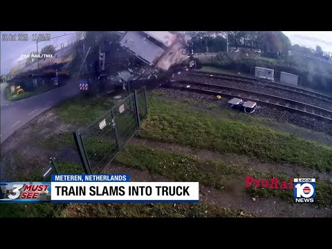 Train crashes through truck on tracks, spilling cargo and debris everywhere