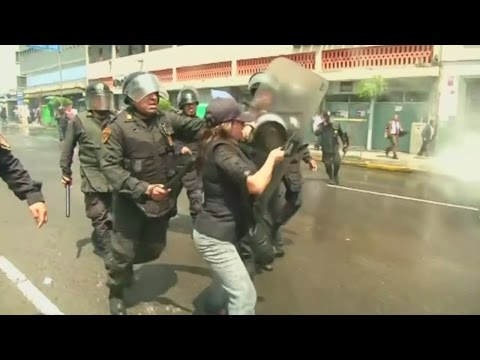 Riot police clash with demonstrators at pay protest in Peru