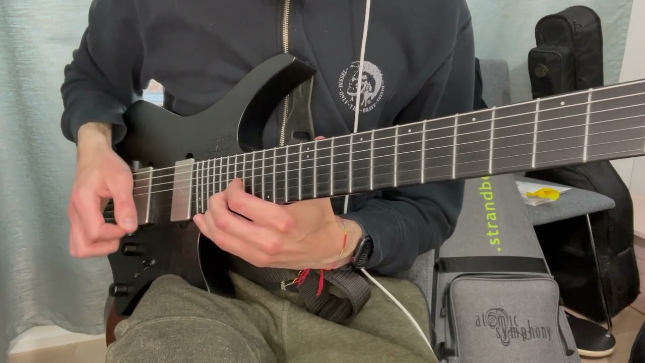 Guitarist demonstrating a tritone hybrid picking lick from Buckethead's Jordan on electric guitar