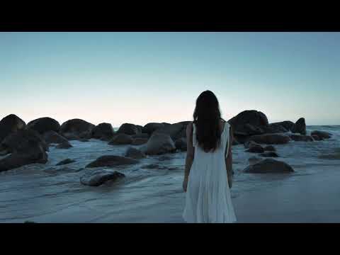Videli Free Footage - Woman walking on beach towards boulders