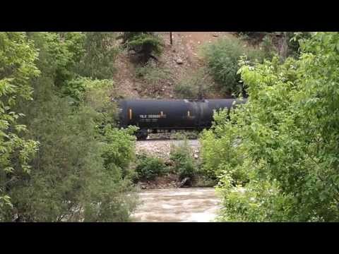 BNSF Train through Glenwood Canyon, next to a very full Colorado River