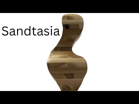 Artist working in the studio.   Contemporary Abstract Wood Sculpture Art.