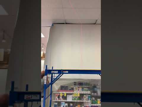 Preparing to wrap an outside corner with wallpaper