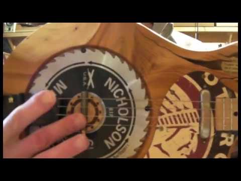 JUNKSVILLE SAW BLADE RESONATOR GUITAR 4 STRING CIGAR BOX INSPIRED THE LOGJAMMER