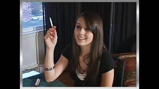 Brunette smoking a long cork-filter cigarette 