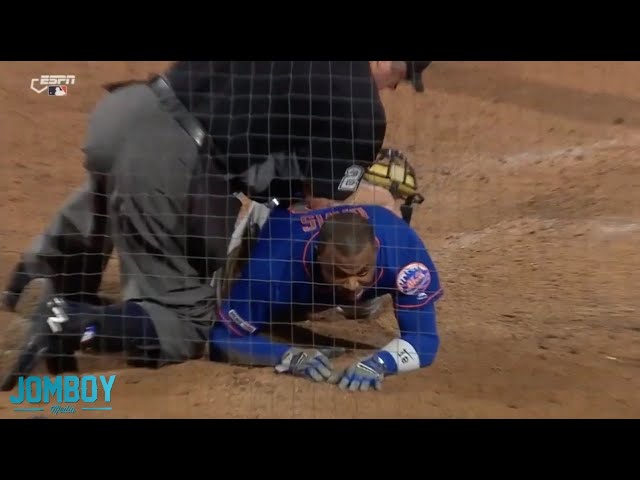 Joe West falls on top of Rajai Davis, a breakdown