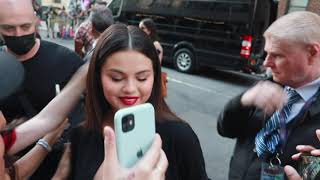 Selena Gomez wears a sexy mini skirt greeting fans