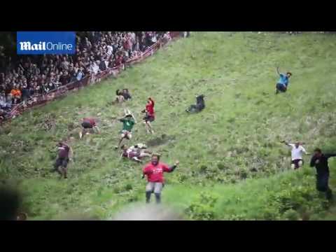 Competitors tumble down Cooper's Hill for annual cheese rolling   Daily Mail Online
