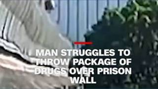 Man struggles to throw package over prison wall