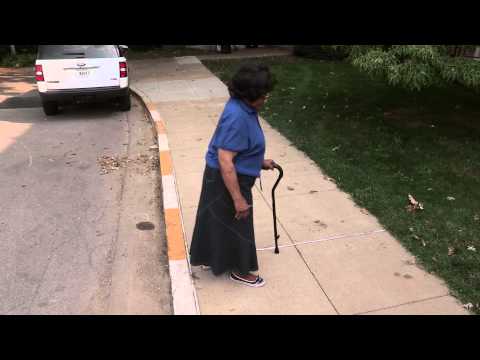 Going up and down a curb using a cane