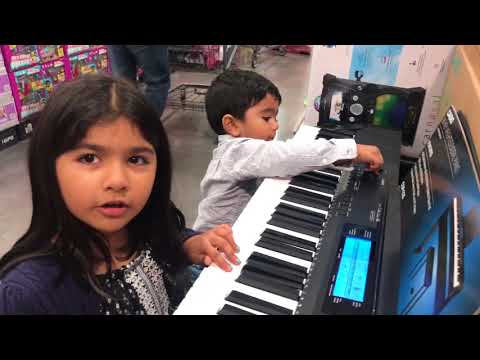 Zara & Zuhair playing the piano at Costco