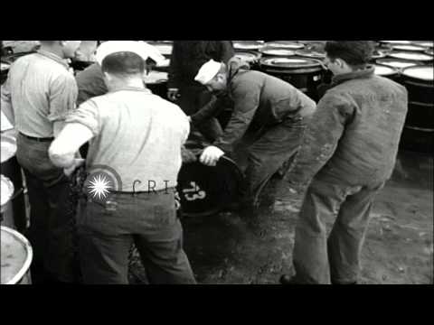 Sailors roll drums of radioactive waste material over the edge of USS Calhoun Cou...HD Stock Footage