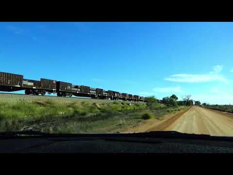 Pacing 5MP2 PN Industrial train, hauled by NR6 and NR56. On a corrugated  gravel road  at Meckering.