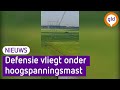 Defensie vliegt tijdens werkzaamheden onder hoogspanningsmast