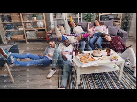 Drunk girls and guys sleeping on floor and sofa after joyful party in apartment