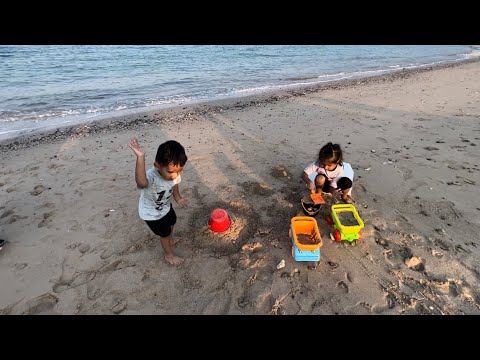 Eman and Arham playing on beach