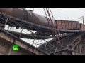 RAW: Train suspended over motorway as bridge ...