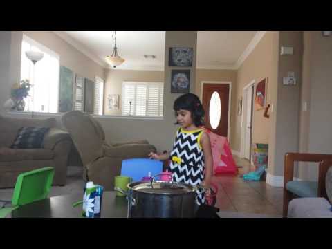 Hasika mixing her chocolate milk