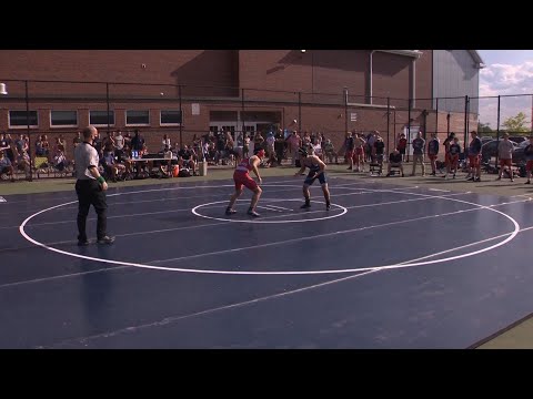 Massachusetts wrestling team moves mats outdoors to allow athletes to compete without masks