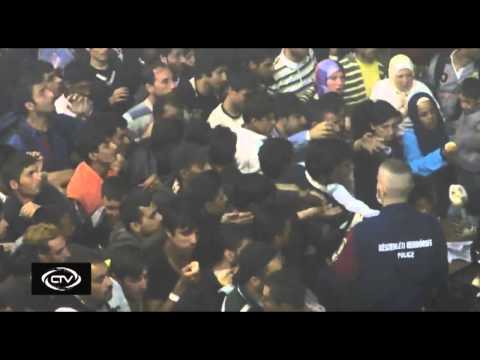 Click to Watch the 'Like animals in a pen': Hungarian officers 'inhumanely' toss food into crowds of hungry migrants video