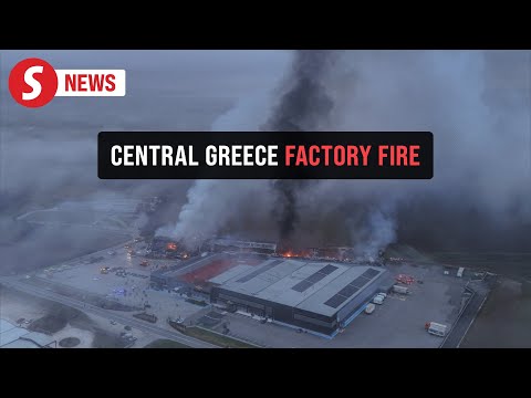 Drone video of thick smoke engulfing town after factory fire in central Greece