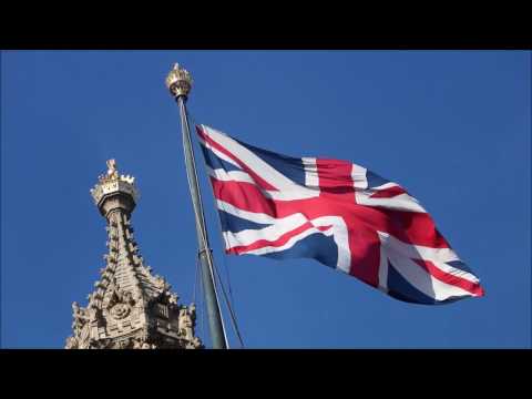 Stock Footage: Union Jack Flag flying above Houses of Parliament, UK