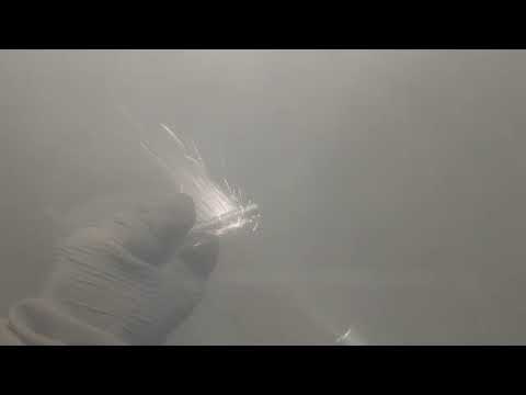 titanium bolt in a sand blasting cabinet