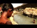 Young rag-pickers dive into dirty water to beat De...