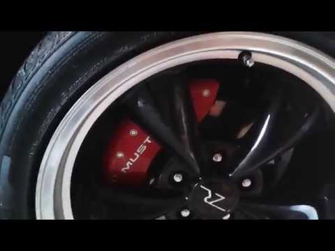 Unboxing and installing red brake caliper covers for 2000 Mustang GT