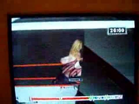 kane throwin' edge over top rope on a table (high graphic)