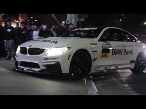 Modified Cars Entering a Steep Driveway