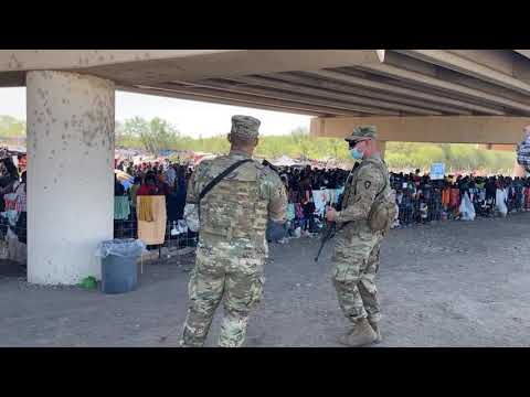 Beneath the bridge where roughly 13,000 immigrants await transport/processing