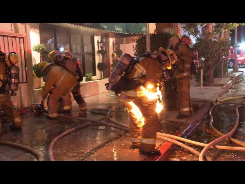 Firefighter catches fire while battling a structure fire in Sherman Oaks, California. (Not injured).