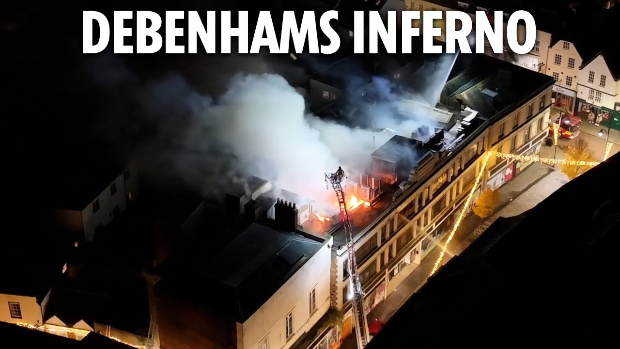 Flames engulf old Debenhams sending smoke billowing into air as dozens of firefighters battle blaze