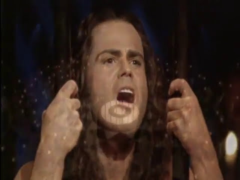 Trailer frame from a filmed Joseph and the Amazing Technicolor Dreamcoat production: technicolor coat and chorus in pyramids set