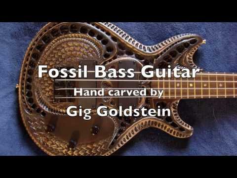Carved bass guitar with old fossil theme