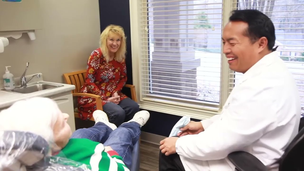 Gainesville dental team member talking with patient