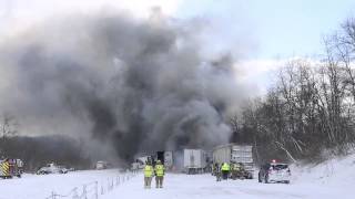 Emergency workers stand back as semi carrying fireworks explodes during fiery crash on I-94